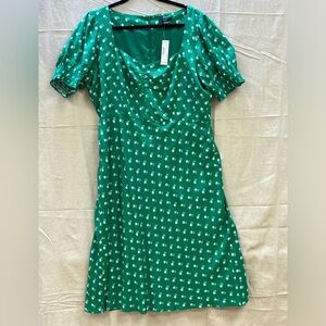 A green floral print dress. Unworn, no noticeable defects. Polyester. Size 16.